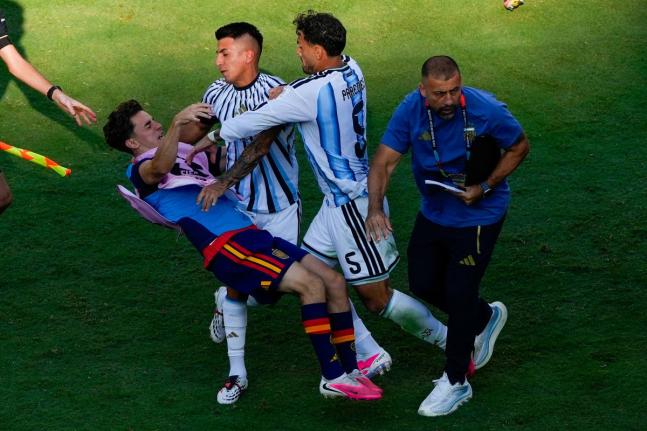 Spain’s Gavi (left) falls as he scuffles with Argentina’s Leandro Paredes (5) and Thiago Almada after the World Cup final between Spain and Argentina in East Rutherford, New Jersey on Sunday, July 19, 2026.  