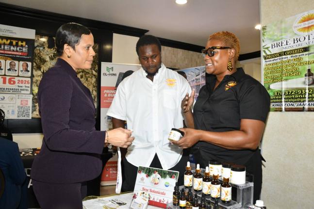 Sobrina Hylton (right) and Jovenne Parker (centre), operators of Bree Botanicals, introduce their skincare products to Gillian Hyde (left), deputy managing director, JN Bank. The occasion was the Small Business Association of Jamaica (SBAJ) Conference, hel