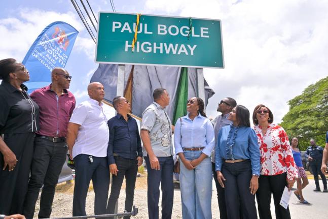 Prime Minister and Minister of Economic Growth and Infrastructure Development, Dr Andrew Holness (centre), unveils the sign officially naming the Paul Bogle Highway during a ceremony at the Morant Bay Roundabout in St Thomas on July 30. 