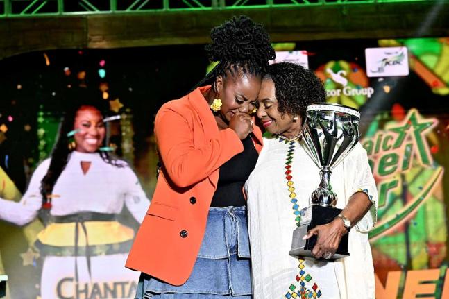 Minister of Culture, Gender, Entertainment and Sport Olivia Grange presents the winning trophy to an emotional Chantal Smalling Stephenson (left), the winner of the Jamaica Gospel Star 2026.