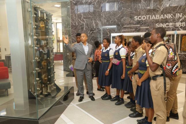 Manager of the Scotiabank Centre Branch, Conrad Wright (left), was delighted to host students of Kingston Technical High and provide them with a brief tour of the branch during their recent field trip, courtesy of the Scotiabank Foundation.