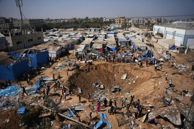 Palestinians inspect the scene of an Israeli airstrike near al-Aqsa Hospital in Deir al-Balah in the central Gaza Strip, August 1.