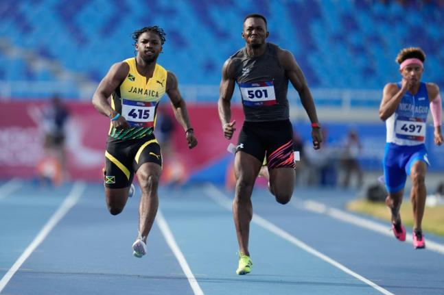 AP Jamaica’s Bouwahjgie Nkrumie (left) and Panama’s Arturo Deliser compete in a men’s 100-metre heat at the Central American and Caribbean Games in Santo Domingo, Dominican Republic, Monday, August 3.