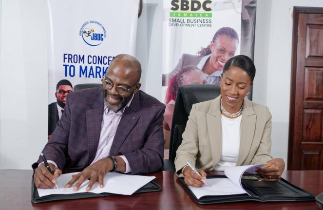 Harold Davis (left), Jamaica Business Development Corporation Acting CEO, Andrea Dempster-Chung, Kingston Creative co-founder and executive director, all smiles while signing a non-binding agreement in July. It will formally joining Jamaica’s national Sm