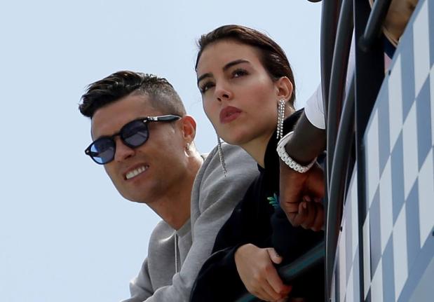 Cristiano Ronaldo (left) and his partner Georgina Rodriguez watch the second practice session at the Monaco racetrack, in Monaco, May 23, 2019. 