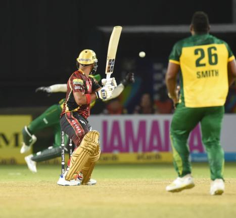 Trinbago Knight Riders' Nicholas Pooran (centre) is given a lifeline after Jamaica Kingsmen wicketkeeper, Shayan Jahangir (partially hidden) spills a chance during a Republic Bank Caribbean Premier League game at Sabina Park tonight. Looking on is Kingsmen