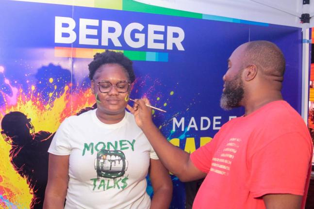 Jodi Thomas gets her face painted by Happy Faces Jamaica’s Clenton White last Tuesday during the Caribbean Premier League (CPL) T20 match at Sabina Park. As the official paint sponsor of the CPL, Berger Paints Jamaica engaged fans both inside and around 