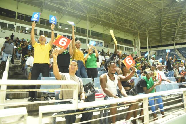 Jamaica Kingsmen spectators celebrate a six during the Caribbean Premier League T20 cricket match against Trinbago Knight Riders at Sabina Park on Saturday night.