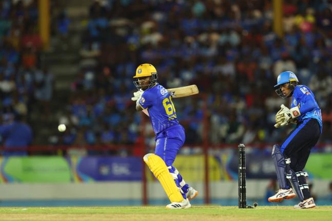 Barbados Tridents’ Sherfane Rutherford (left) plays square of the wicket during a Republic Bank Caribbean Premier League cricket game against the St Lucia Kings on Sunday. St Lucia Kings wicketkeeper, Jewel Andrew, looks on.  