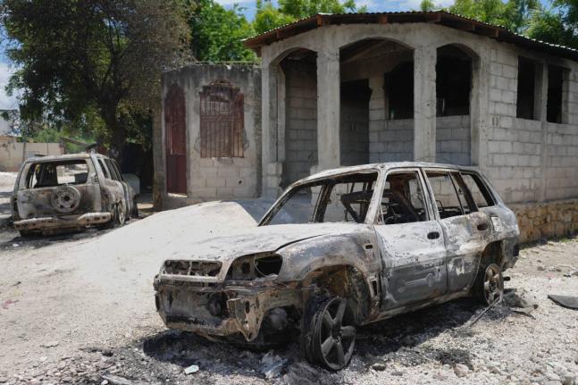 Vehicles that were set on fire by armed gangs sit in the Cite Soleil neighborhood of Port-au-Prince, Haiti, May 12.