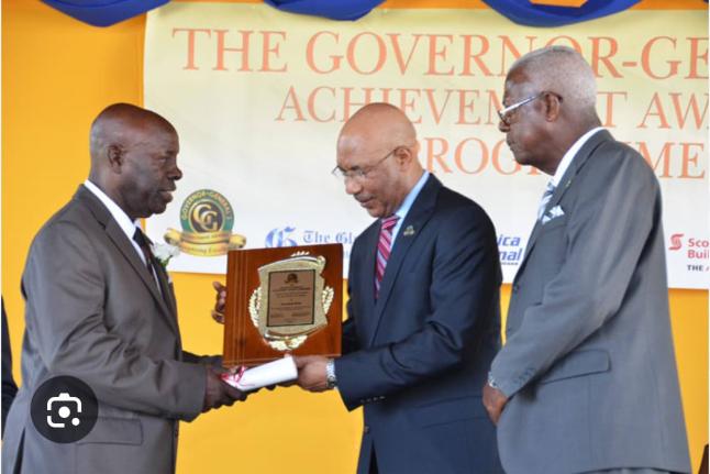 Jerry Reid (left) accepts the Governor General Award from His Excellency Sir Patrick Allen (centre). Looking on is former St James Custos Ewen Corrodus.