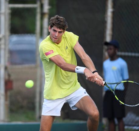 Blaise Bicknell plays a two-handed backhand during his Kingston Open round-of-32 game against Max Purcell at the Liguanea Club on Tuesday.