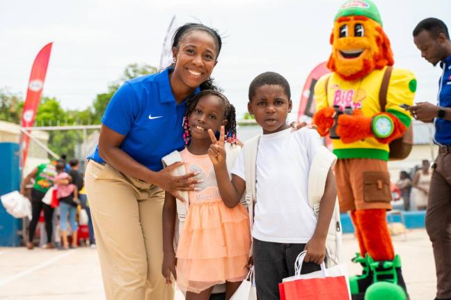 Pocket Rocket Foundation founder and Chairwoman Shelly-Ann Fraser-Pryce shares a moment with Serena Whyte (centre) and Kyle Ferron during the foundation’s annual back-to-school treat in Waterhouse, St Andrew, on August 12.