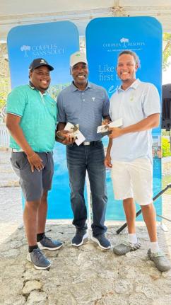 Gary Holgate (centre), general manager, Couples Tower Isle, presents Oshane Haye (left) and Zandre Roye with prizes for winning first-place gross with a score of 61 at Sunday’s annual Couples Resorts Ocho Rios Charity Golf Tournament held at the Sandals 