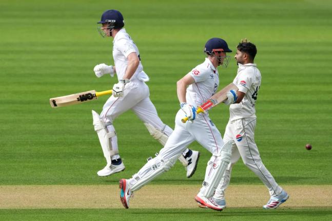 
England’s Harry Brook (centre) and batting partner Dan Lawrence run between the wickets as Pakistan’s Khurram Shahzad (right) looks on, on day three of the second Test match in London yesterday.