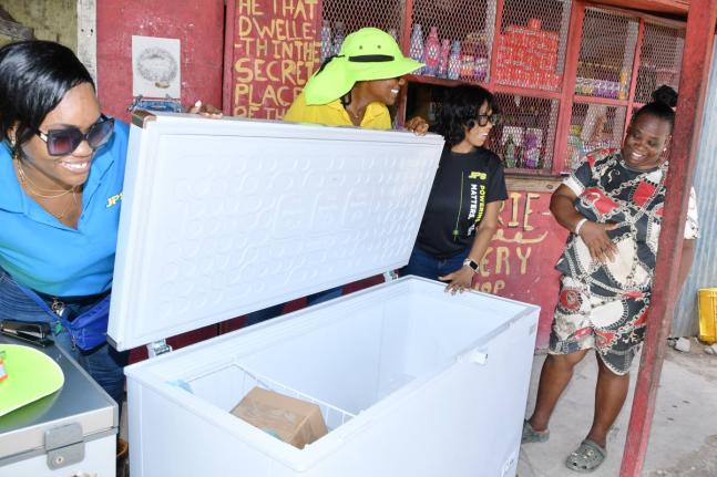 Valerie Daley (right), a Riverton Meadows business operator, receives a new freezer from the Jamaica Public Service (JPS) in exchange for her old unit. Joining her are (from left) JPS Community Relations Officers Kerrica McGregor and Nahesha Patterson, and