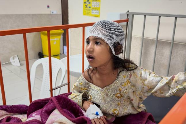 A child wounded, according to Tasnim news agency, in a strike on a home where a wedding was being held in Kuhestak, southern Iran, receives treatment at a hospital in Menab, Iran, early Wednesday.