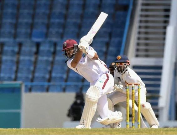 West Indies opener Brandon King (left) drives on his way to an unbeaten 51 during the second Test against Sri Lanka at the Sir Vivian Richards Stadium in North Sound, Antigua yesterday. Looking on is Sri Lanka wicketkeeper Kusal Mendis. 