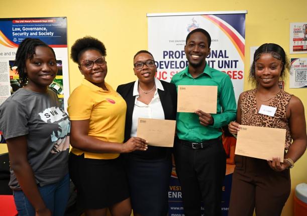 Nordia Barrett-Lewis (centre), founder and chief executive officer of the Atlanta, Georgia-based Barrett Immigration, with the four University of the West Indies students who received $1 million in scholarships that she recently presented to them on August