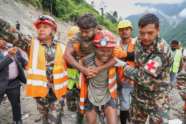 Soldiers rescue a worker alive from a tunnel during an ongoing operation at the Trishuli-3A hydropower project in Nepal’s Rasuwa district, Friday.