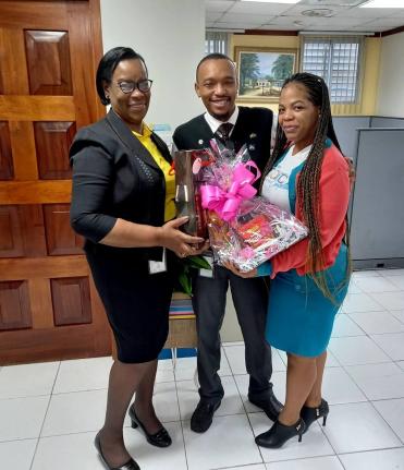 Paulette Chambers-Salmon (left), recently retired business relationship and sales manager, JN Bank May Pen branch and Old Harbour MoneyShop, presents Michael Bernard, senior sales officer and Tanicia Fisher, sales officer, with tokens of appreciation for t