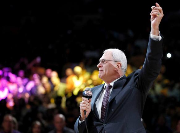 Los Angeles Lakers coach Phil Jackson holds up his NBA championship ring during a ceremony before the Lakers’ basketball game against the Houston Rockets, in Los Angeles on October 26, 2010.