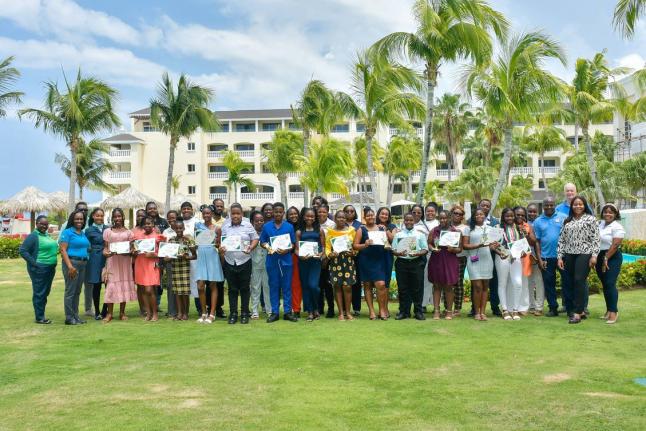 Staff members and parents of the Iberostar Rose Hall team join the 15 awardees of the hotel’s PEP Scholarship Programme and Back-to-School Book Initiative for a group photo following the presentation ceremony.