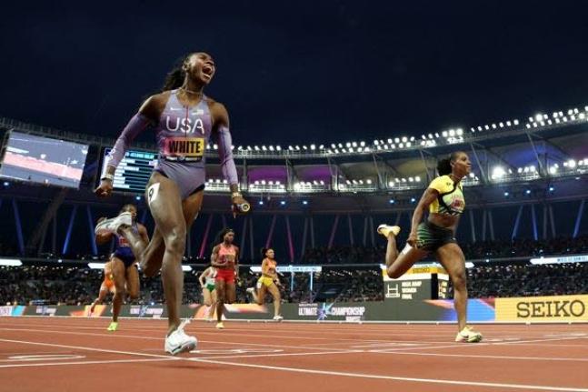 Kayle White (left) of the United States crosses the line just ahead of  Jamaica’s Jonielle Smith in the mixed relay final at the Ultimate Championship  in Budapest, Hungary yesterday. 
