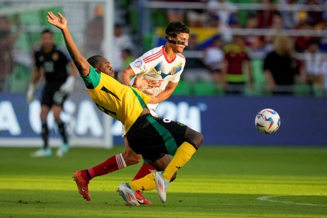 Jamaica’s Michail Antonio, left, and Venezuela’s Yordan Osorio compete for the ball during a Copa America Group B soccer match between Jamaica and Venezuela, Sunday, June 30, 2024, in Austin, Texas. 
