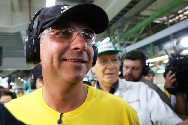 Opposition presidential candidate Senator Flavio Bolsonaro wears protective glasses and headphones during a visit to a Honda motorcycle factory in the Manaus Free Trade Zone during a campaign event in Manaus, Amazonas state, Brazil, Friday.