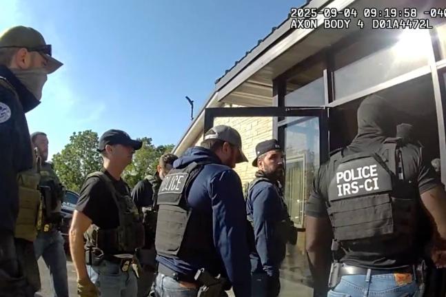 AP 
This image from Homeland Security Investigations body camera video shows federal authorities entering the Nutrition Bar Confectioners plant in Cato, New York on September 4, 2025. 