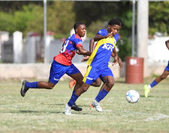 
Clan Cathy’s Amer Webb (left) chases Innswood’s Antoine Parkes during their ISSA Manning Cup football game at Alpha Boys’ Institute in Kingston yesterday. 