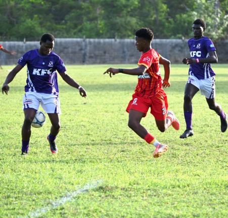 Kingston College’s Rodney Grandstand (left) is challenged by Cornwall College’s Shakeem Gibson (centre) as Kingston College’s Ricardo Gibbon looks on during their ISSA Super Saturday Festival match at Cornwall College on September 12, 2026.