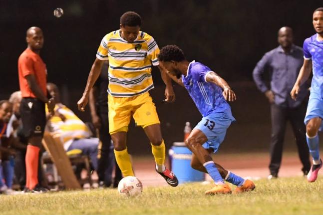 Treasure Beach’s Daniel Hardy (left) tries to get by Molynes United’s Shavaun Reid during their Jamaica Premier League football game at Stadium East yesterday.