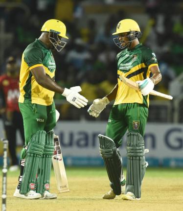 Keemo Paul (right) is congratulated by Rovman Powell after scoring 50 runs against the St. Kitts and Nevis Patriot in their Caribbean Premier League T20 Cricket match at Sabina Park in August.
