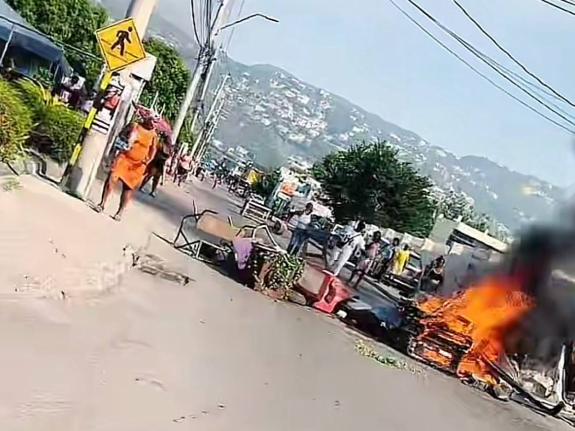 A fiery roadblock mounted along Red Hills Road in St Andrew by residents protesting a fatal police shooting on September 16, 2026. - Contributed photo