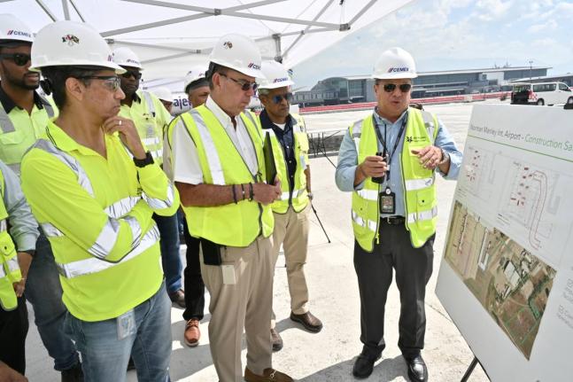 From left: Country Manager of Cemex Jamaica and Managing Director of Carib Cement, Jorge Martinez; Minister of Energy, Transport and Telecommunications, Daryl Vaz; and Airports Authority of Jamaica Chairman, Dr Douglas Lindo listen as PAC Kingston Airport 