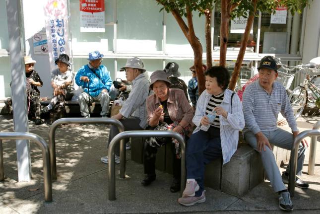 Elderly people rest under the shade of a tree in Tokyo, Japan. - AP file photo