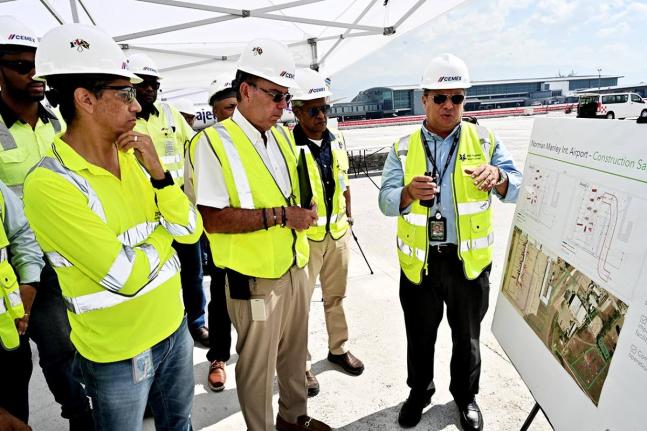 Caption: From left: Jorge Martinez, country manager of Cemex Jamaica and managing director of Carib Cement; Minister of Energy, Transport and Telecommunications Daryl Vaz; and Airports Authority of Jamaica Chairman Dr Douglas Lindo listen as PAC Kingston A