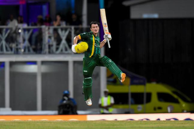 Jamaica Kinsmen batsman Maaz Sadaqat leaps in celebration of scoring a century against the Barbados Tridents in a Republic Bank Caribbean Premier League eliminator at the Kensington Oval in Barbados earlier tonight. 