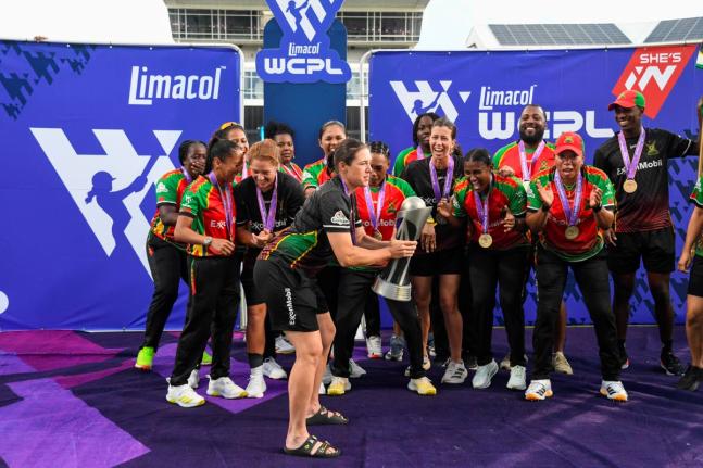 The Guyana Amazon Warriors Women celebrate winning the Limacol Women’s Caribbean Premier League after a two-wicket victory over the Trinbago Knight Riders at the Kensington Oval yesterday.