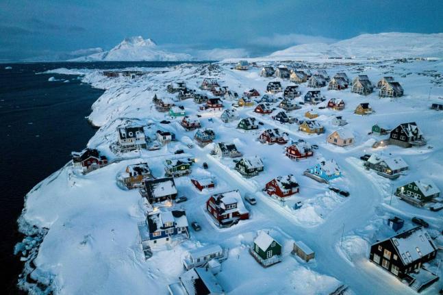 Houses covered in snow on the coast of a sea inlet of Nuuk, Greenland. - AP photo