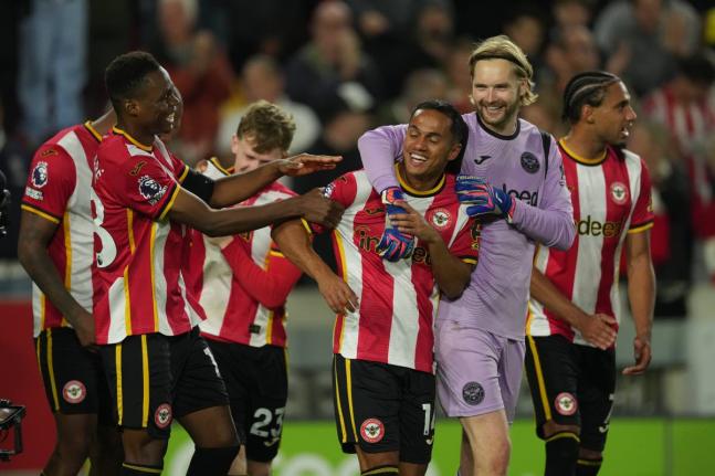 Brentford players celebrate after the Premier League  match between Brentford and Chelsea in London, England yesterday.