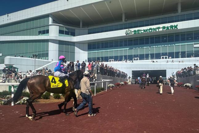 AP 
In this photo made with a smartphone, jockeys ride their horses into the newly-opened Belmont Park in Elmont, New York, on Friday.