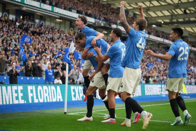 Brighton players celebrate after the third goal during the English Premier League football match against Arsenal in Brighton, England, yesterday.