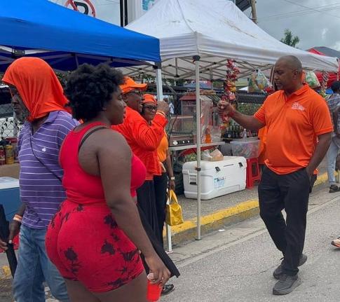 Opposition Spokesman on Finance Julian Robinson greeting People’s National Party supporters on Sunday.