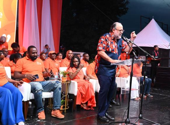 People’s National Party President Mark Golding addresses the party’s 88th Annual Conference in Savanna-la-Mar, Westmoreland, on Sunday as his wife, Sandra, and other party officials look on.