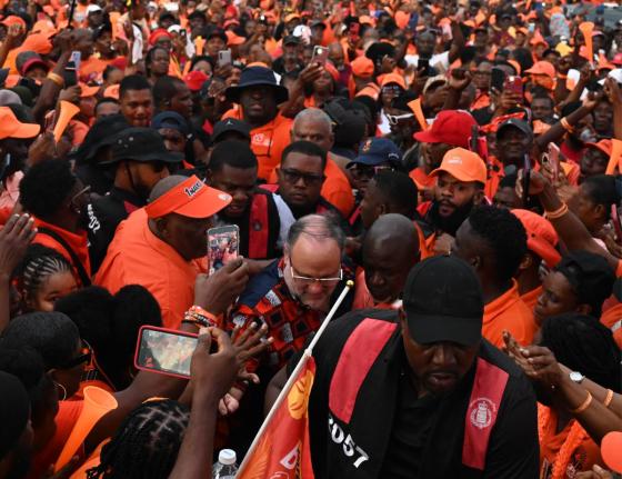 People’s National Party President Mark Golding makes his way through a sea of Comrades on his way to the stage at the party’s 88th Annual Conference in Westmoreland on Sunday.