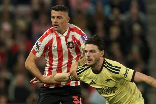 Sunderland’s Granit Xhaka, left, and Arsenal’s Declan Rice challenge for the ball during the English Premier League soccer match between Sunderland and Arsenal in Sunderland, England, Saturday, September 12, 2026. 