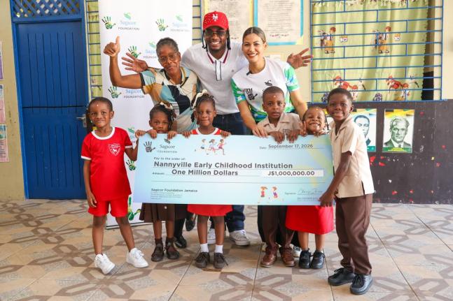 Recording artiste and 2026 Sagicor SIGMA Corporate Run patron Kemar ‘Ding Dong’ Ottey (centre) celebrates with students of Nannyville Early Childhood Institution following the presentation of J$1 million to the school. Sharing in the moment are Beverle